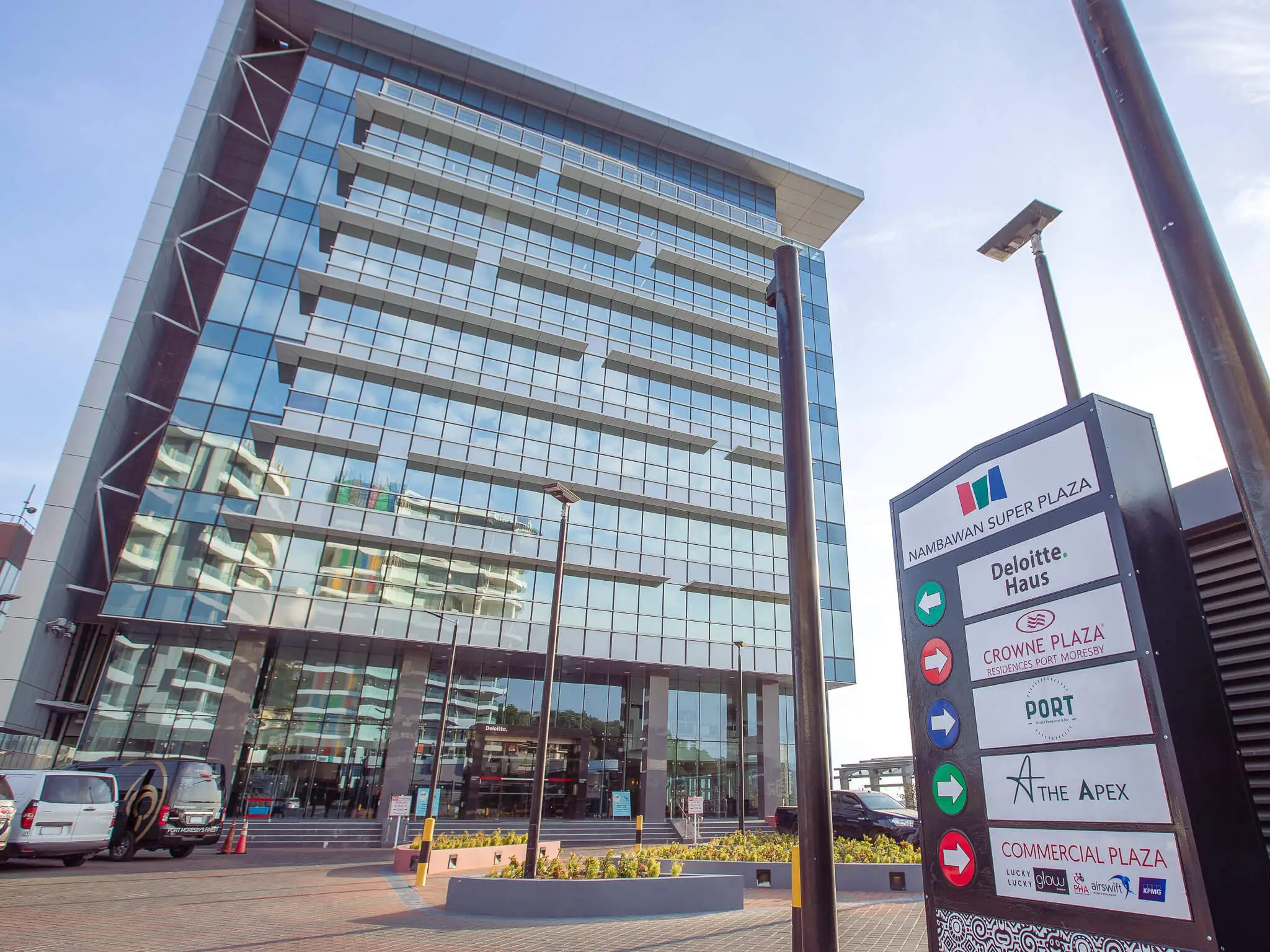 Exterior view of Deloitte Haus and Nambawan Super Plaza directional sign